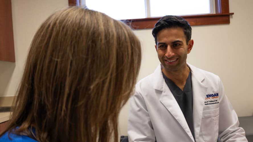 Dr. Iyengar with a patient giving a consultation